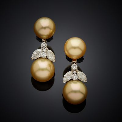 a pair of pearl and diamond earrings