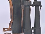 an old pair of binoculars sitting next to each other on a white surface