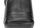 a close up of a black purse on a white surface
