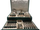 a green case with silverware in it on a white background