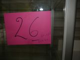 a pink sign that says 26 on it in the window