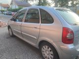 a silver car that is parked on the side of the road