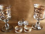 two glass goblets sitting next to each other on a table