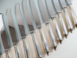 a lot of knives that are sitting on a table