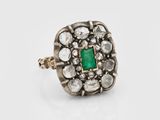 an antique emerald and diamond cluster ring