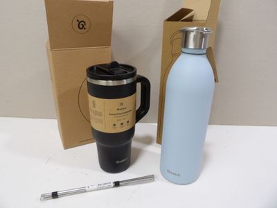 a coffee cup and a water bottle next to a cardboard box