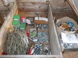 a wooden box filled with assorted items on the ground