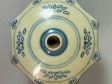 a blue and white plate with a flower design on it