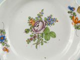 a plate with a flower design on it on a table