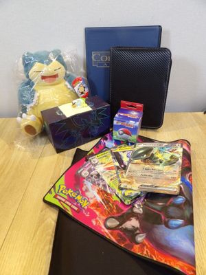 a pokemon trading card game on a table next to a box of cards