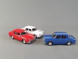 three toy cars sitting next to each other on a table