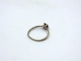 a close up of a ring on a table with a white background