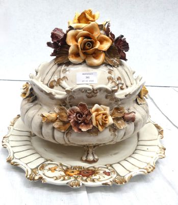 a three tiered cake on a plate with flowers on it