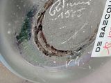 a close up of a glass of water with a sticker on it