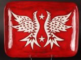 a red plate with a white bird design on it