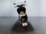 a motorcycle parked in a room with a white wall