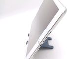 a tablet computer sitting on a stand on a white surface