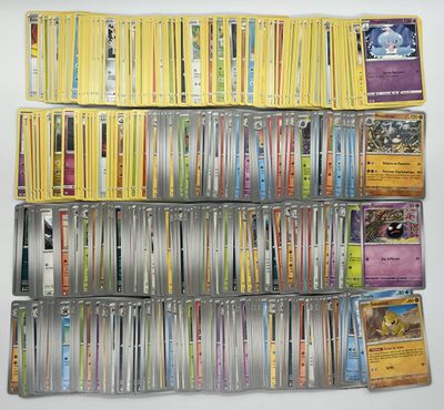 a large collection of pokemon trading cards on a white surface