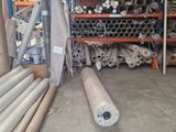 many rolls of metal on the shelves in the warehouse