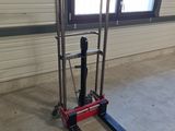 a fork lifter in a garage with a window in the background