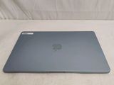 an apple macbook air laptop computer sitting on top of a bed