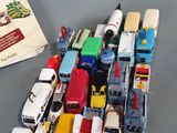 a lot of toy cars and a book on the table
