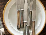 a lot of knives on a plate on the table