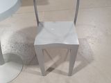 a white chair and a white table in a room