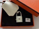 an orange and white gift box with a keychain and a key chain