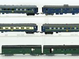 four different train cars on display on a white surface