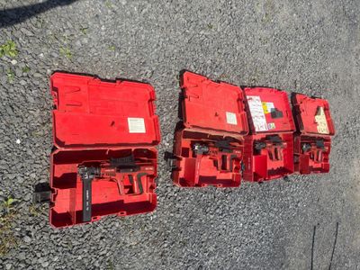 three red boxes are lined up on the ground next to each other