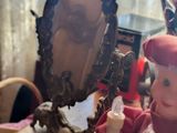 a doll that is sitting in front of a mirror