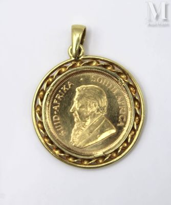 a close up of a gold coin with a chain around it