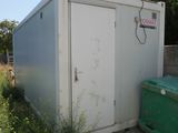 a white container sitting next to a green trash can