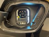 a close up of a car ' s rear door with an electric plug