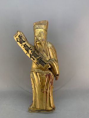an image of a gold statue of a man holding a baseball bat