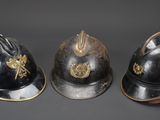 three helmets are lined up in a row on a gray surface