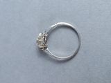 a silver ring with a diamond in it on a table