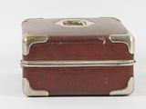 a small brown suitcase sitting on top of a white surface