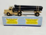 a toy truck with a large pipe attached to it ' s back