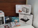 a small table with a coffee maker and other items on it