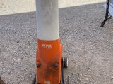 an orange and white fire hydrant sitting on the side of the road