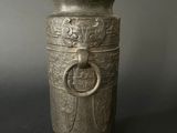 an image of a silver vase with a ring on the handle