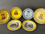 six wednestone plates with yellow rims and black and white images