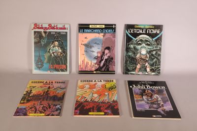 several books are lined up on a table in front of a white wall