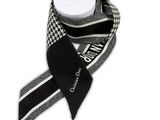 a close up of a black and white scarf with a white box