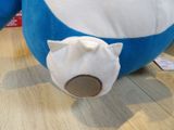 a large blue and white stuffed animal on the floor