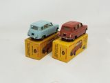 three toy cars sitting on top of boxes on a white surface