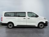 the white van is parked on the concrete floor in the room
