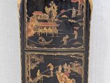 an image of a black and gold painted cabinet with oriental scenes on it